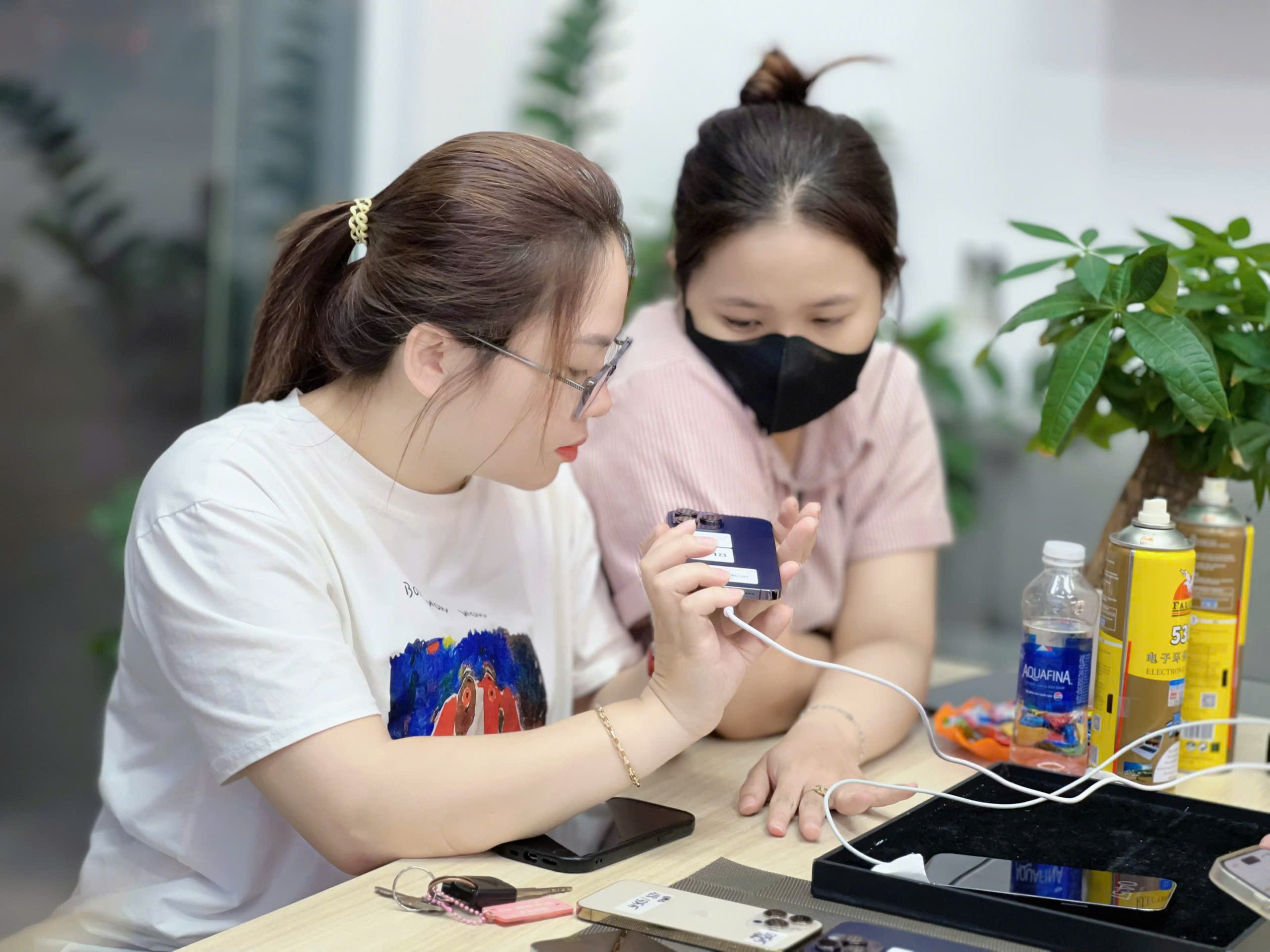 Khách hàng kiểm tra iPhone 15 Pro cũ tại Táo 247 Đà Nẵng trước khi mua