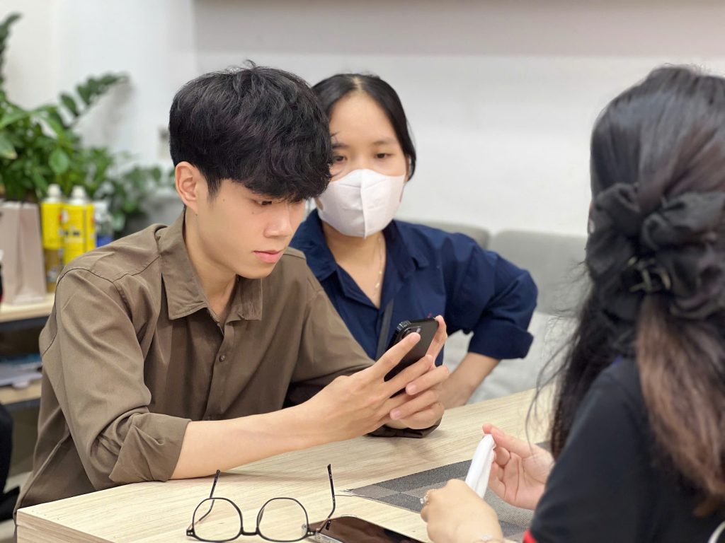 Sinh viên kiểm tra iPhone cũ trước khi mua tại Táo 247 Đà Nẵng
