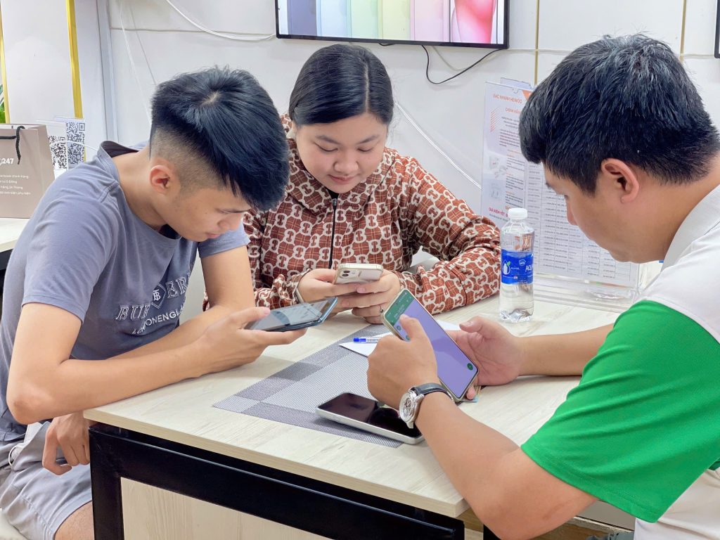 Khách hàng test iPhone trực tiếp tại cửa hàng Táo 247 Đà Nẵng trước khi mua
