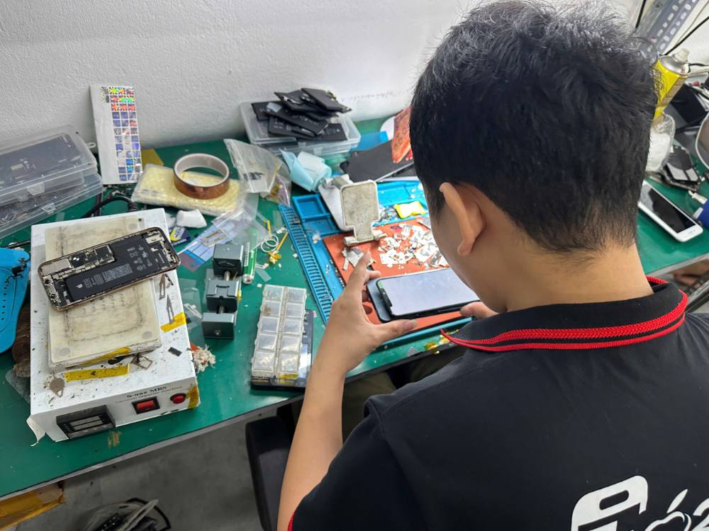 Kỹ thuật viên Táo 247 kiểm tra iPhone trước khi sửa chữa