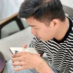 Khách kiểm tra iPhone cũ trên tay tại quầy Táo 247 trước khi mua