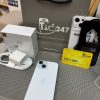 iPhone 15 màu xanh nhạt cùng túi giấy, tai nghe không dây và thẻ VIP Táo 247