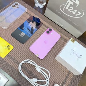 iPhone 16 màu hồng trên bàn tư vấn Táo 247 cùng cáp sạc